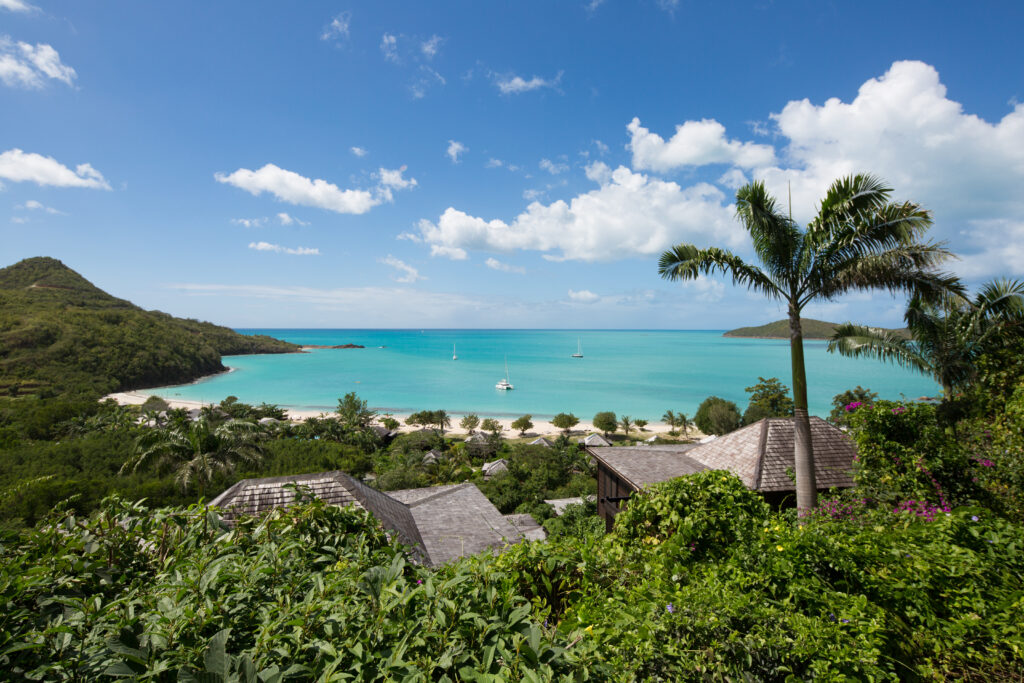 Lose yourself in a tropical, all-inclusive Caribbean paradise! There’s truly nothing else quite like the Caribbean. Deservedly renowned for glorious beaches, friendly people, and a toasty climate, it’s hard not to love these dreamy islands. Antigua stands proudly in these ranks. Blessed by 95 miles of exceptional coastline, you’ll find sands of white, pink, and black, all melting into warm, crystal-clear waters. With reefs and a thriving marine life to gaze at, swimming and snorkelling here is amazing. As if the beaches aren’t already some of the most impressive in the world, it’s also well-known there are even 365 of them– one for every day of the year! It’s far from all about the beaches, however. Dotted with colourful villages across the undulating, inland slopes, Antigua is buzzing with a friendly atmosphere. First settled by British colonists in 1632, there’s still a distinct English feel. Travelling across the island, just 13 miles across, you’ll find plenty of rich history and fun activities. The exquisite food is another great reason to visit. Authentic Caribbean cuisine can be found all over, from beachside shacks to waters-edge restaurants. This remarkable range includes delicious seafood too. Antigua is simply bursting with interesting sights to be uncovered. All-inclusive holidays in Antigua All-inclusive holidays in Antigua hardly resemble the dreaded myths. Far from buffet crowds and jostling for sun beds, all of our specially hand-picked properties are all-inclusive, and have delicately fostered a welcoming, intimate atmosphere, sprinkling elegance in all directions.  Carlisle Bay –  Exuding pure luxury from a white crescent beach in front, and tropical rainforest behind, Carlisle Bay has one of the loveliest spots in Antigua. With extensive gardens, palatial colonial-style architecture, and minimalist interiors, it’s both chic and discrete, yet unpretentious. The vibe is relaxed, and service is most definitely with a smile. The Beach Terrace Suites open directly onto the sand, stretching deep into glorious reefs bursting with marine life. Their spa is brilliantly relaxing, a sense which spills into the grounds. Everywhere you step, you’ll feel at peace. They also offer a variety of water sports, a gym, and tennis courts, to keep yourself active whilst enjoying the weather. Here, all-inclusive means 3 fantastic restaurants and a beach-side bar, Cool Kids Club, and Yoga Pavilion. Curtain Bluff –  A fantastic blend of classic seaside elegance and intimate charm, Curtain Bluff is a welcoming destination, well-suited to pampering both the mind and soul. The entire resort feels like retreating into a private villa with friends. It’s understandable so many ‘returners’ find themselves back each year. We’d understand if lounging, cocktail in hand, fulfils all your desires. However, Curtain Bluff also has plenty of activities, including diving and water sports, all included in the room rate. The Cee Bee Kid’s Club is perfect for ensuring they have ample entertainment, whilst allowing you to focus on the all-important relaxation. Experience the best of both worlds, prioritising everyone’s satisfaction. Hermitage Bay –  For an idyllic outlook, Hermitage Bay is hard to beat. Reached by a long dirt track on the west coast of this island, and surrounded by 140 acres of wooded wilderness, it’s a very private adult-only retreat. Looking back from the beach, the cottages blend effortlessly into the scenery, with a fabulous contrast of colours between the dark wood, the lush green vegetation, and the aquamarine water. The only sounds are rolling waves against the glittering shoreline, and rich fragrances fill the air. With plenty of time to do nothing, you can also choose from a variety of activities, from tours of the grounds to SCUBA diving, or golf and tennis on their championship grounds. Each day, you can enjoy shifting breakfast, lunch, and supper options, accompanied by snacks and beverages whenever you desire.  Exploring Antigua Antigua has an intriguing history undoubtably worth engaging with. The Museum of Antigua and Barbuda, found in the middle of St. John’s, just 30-minutes from the resort, charts much of the island’s development in an engaging fashion. It’s even believed to be the oldest building in town itself! Visiting Devil’s Bridge is a reminder of the darkest aspects of Antigua’s past. This natural arch is so-named because slaves forced into labour on the nearby sugar plantations would commit suicide here, apparently compelled to do so by the devil. Now, it stands as both a symbol of the island’s storied history, and a staggeringly impressive natural feature. Nelson’s Dockyard is another worthy attraction. A World Heritage Site, it was first developed as a British Naval base in 1725, and briefly fell under Lord Nelson’s command. No trip to Antigua is complete without a visit to Shirley Heights. Excursions here are accessible by car or on foot, via the Lookout Trial, whereupon you’ll find stunning ocean views overlooking Montserrat and Guadeloupe. This former fortress is the perfect place for a sundowner. Local bands also play live music on Sundays, with drinks and a barbeque taking over the afternoon. It’s an unbelievable spot to watch the sunset, with Caribbean and international music washing over you. All-inclusive holidays in Antigua Now is the time to adventure to Antigua! There’s no better way to visit than embracing the charming decadence of our all-inclusive properties. Speak to our resident experts Philippa or Gemma (01306 264 005) to start your planning today!